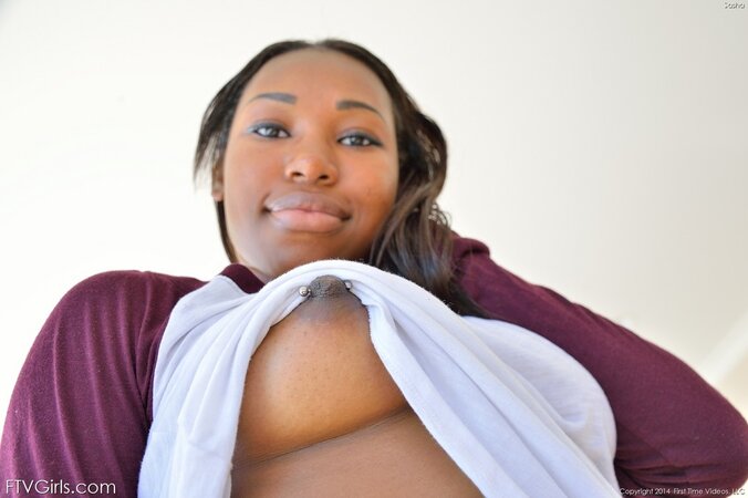 Slutty black chick in a checkered skirt takes own fingers deep in back hole
