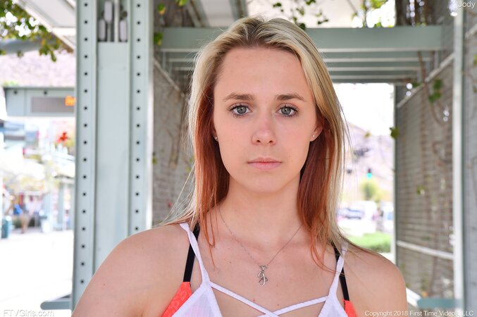 Girl in white top and pink shorts poses on camera in various public places