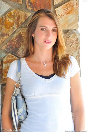 Young girl with small boobs takes white T-shirt and jeans off going to balcony