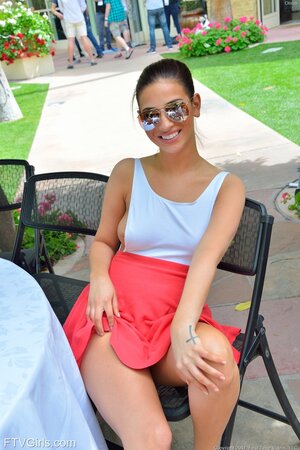 Beauty takes sunglasses off exposing beautiful eyes and something else