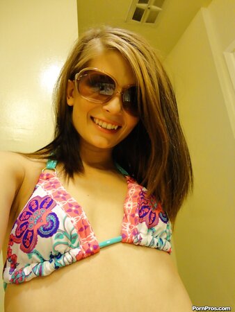 Teen in floral swimsuit comes to bathroom where she takes pictures of naked body
