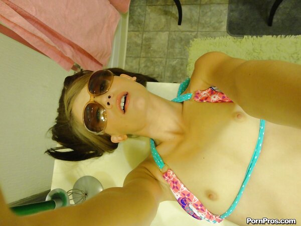 Teen in floral swimsuit comes to bathroom where she takes pictures of naked body