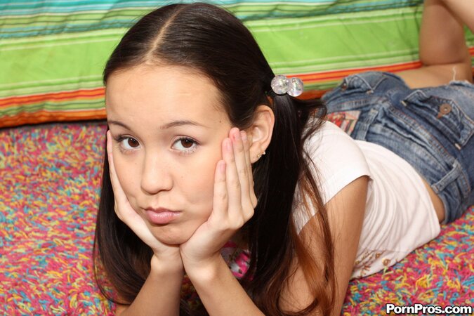 Young Asian coed has long pigtails to grab them during passionate fuck