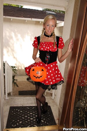 Naughty girl takes off her Halloween dress and poses in sexy stockings