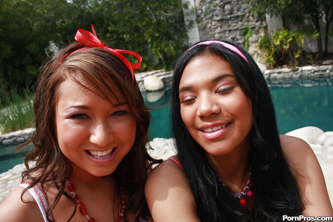 Black girl in pink headband and lesbian friend have fun by Cadillac Escalade toy