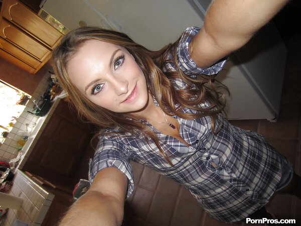 Babe shows off her shaved pussy and boobs on camera that she holds in hands