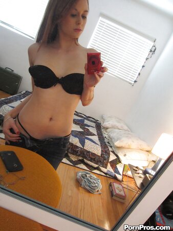 Indecent chick with red hair takes obscene selfies in front of a mirror