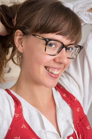 Long-legged girl with glasses gets naked to brush her hairy cunt