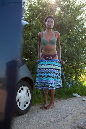 Leggy African girl with curly hair gets dressed after quick sex in the car