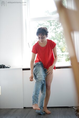 Hairy slender teen puts panties on to hide pussy in front of the window