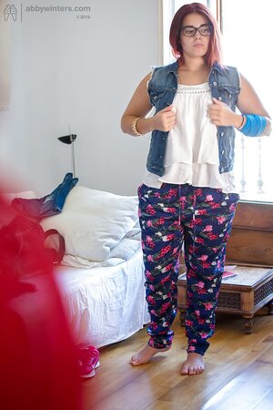Plus-sized redhead on pink lingerie to get fully dressed next to the window