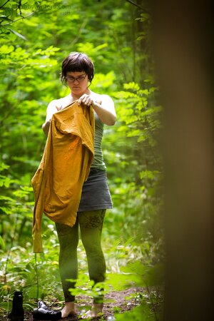 Chubby chick with glasses puts on her clothes after posing nude in the wood