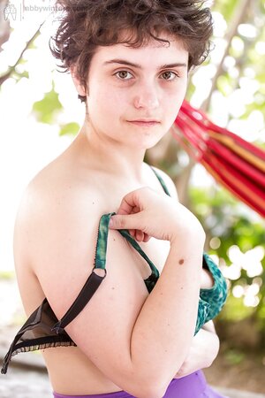 Cropped hair Kyna D removes purple tights to expose natural bush outdoors