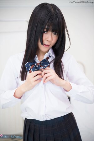 Young Japanese girl gets naked looking into the camera with her eyes full of lust