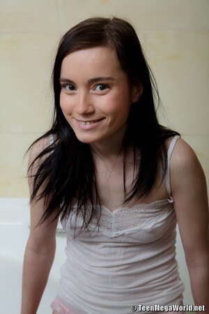 Girl washes soapy body and masturbates shaved pussy using dildo in bathroom