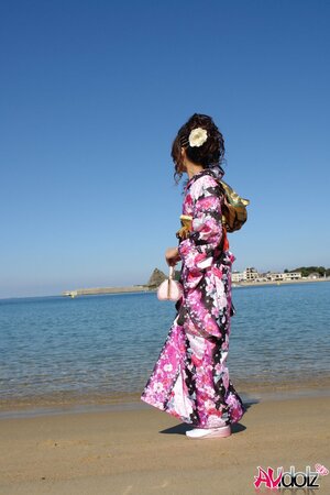 Asian slut knows her business and walks down the ocean shore attracting boys