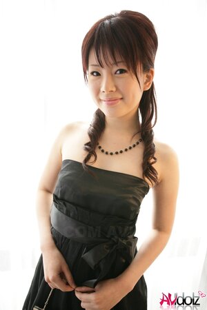 Horny Eastern bitch in a black dress is femme fatale exposing tiny boobs