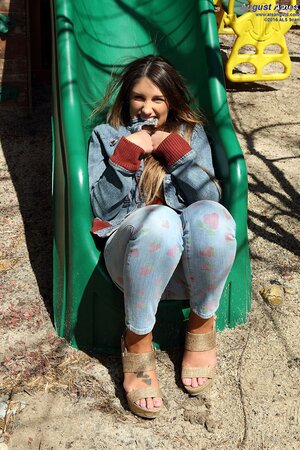 Gorgeous nymph with big jugs flashes her shaved snatch outdoors on swing