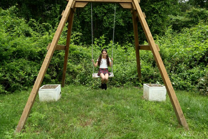 Pigtailed college girl in boots has fun with pussy spreader sitting on swing