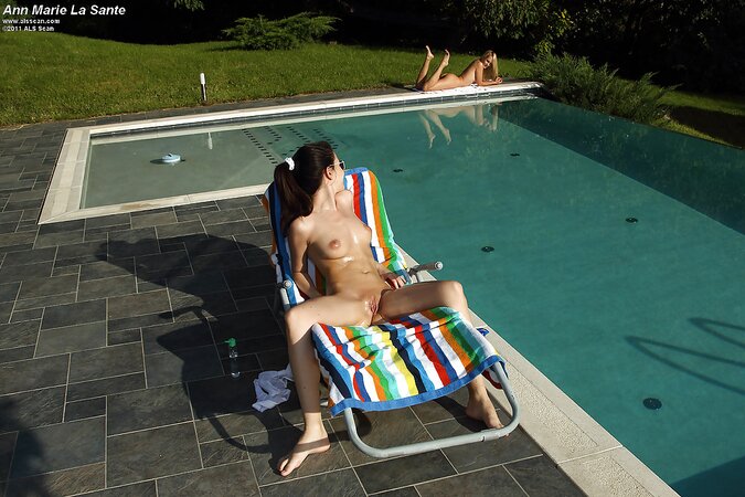 Whore plays dirty games on the chaise lounge stripping in front of another female