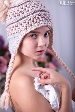 Young fallen angel with a knit cap and leg warmers shows off all the fun parts