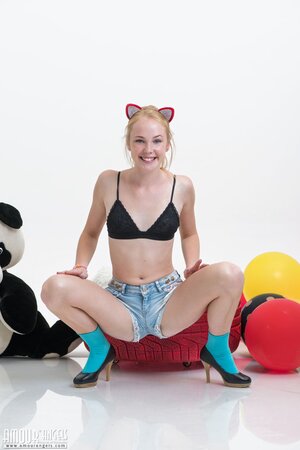 Love with pussy ears hugs and rides a plush panda with balloons in her hands