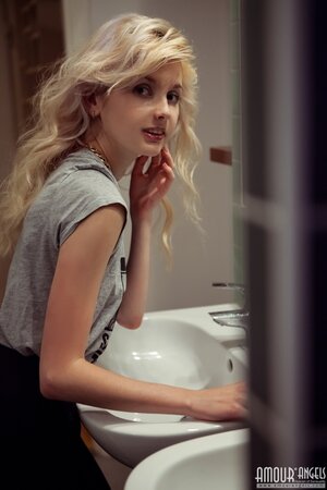 After bathroom naughty blonde doesn't mind stripping naked for a photographer