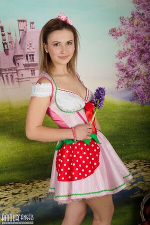 Babe with flower in hands flaunts her pussy against the background of wallpaper