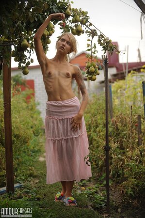 Skinny blonde wakes up and goes in the garden to play with her pretty cat