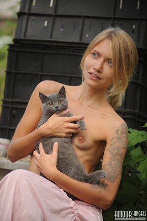 Skinny blonde wakes up and goes in the garden to play with her pretty cat