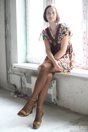 Girl poses in dress and then takes it off opening her shaved snatch on windowsill