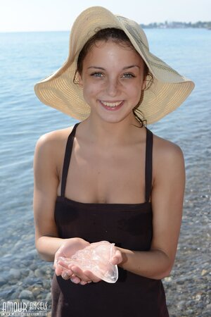 Teen sweetie with freckled face likes to walk without clothes on the beach
