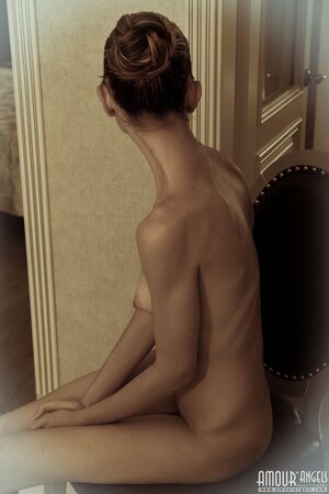 Before going in the shower slender gal peels off black lingerie in the corridor