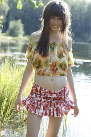 Innocent teen with bangs and slender body flashes tits and pussy by the lake