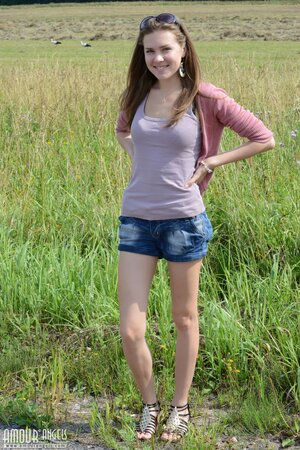Near stack of hay good-looking teen decides to relax fully naked under the sun