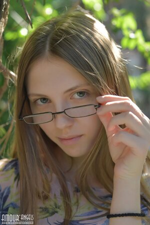 On a sunny day skinny bookworm finds quiet spot near reeds and takes off clothes