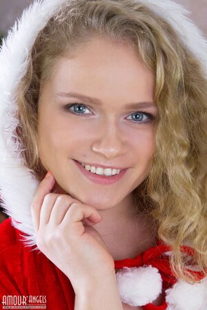 Slut in a red Christmas dress celebrates in the nude under an X-mas tree