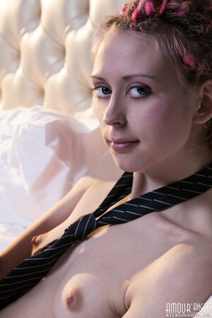 Euro minx with dreadlocks poses in the bedroom dressed only in a sexy necktie