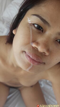 Oriental minx is rammed in her hairy snatch on white bedsheets and gets facialized