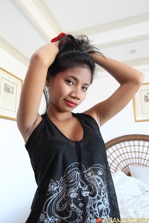 Gorgeous young woman from the Philippine Islands passionately gets naked