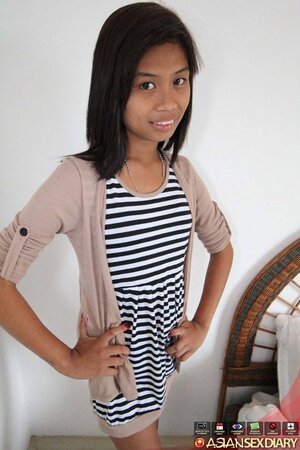 Cute Asian girl takes off a striped dress in exchange for some money