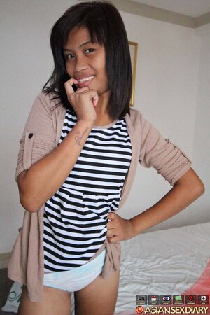 Cute Asian girl takes off a striped dress in exchange for some money