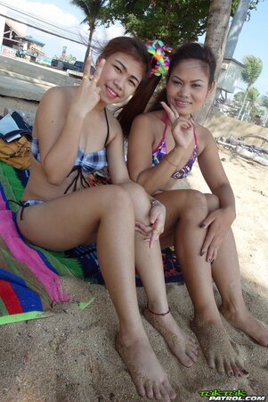 Thai babes rest on a beach and pose in tight bikini flashing innie navels