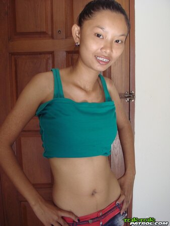 Skinny young Asian woman satisfies her sexual cravings getting naked