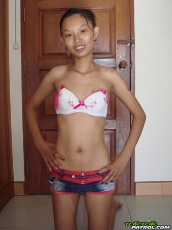 Skinny young Asian woman satisfies her sexual cravings getting naked