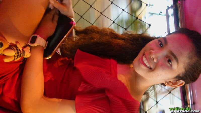 Thai slut in a red dress never stops smiling even in the backseat of a taxi