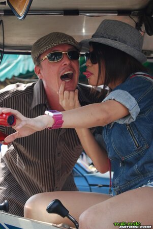 Joyful exotic teen agrees to pose with mature guy near auto rickshaw