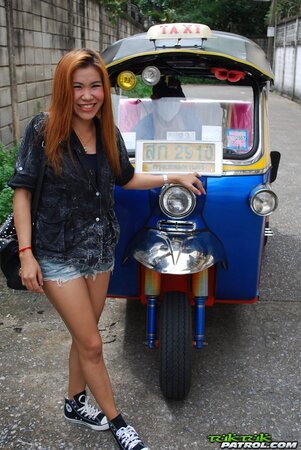 Clothed Thai girl with a cute face and red hair can brag about wonderful legs