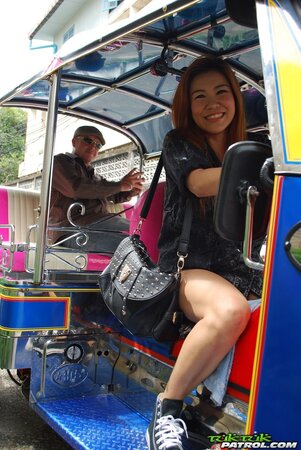 Clothed Thai girl with a cute face and red hair can brag about wonderful legs