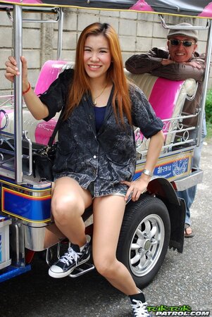 Clothed Thai girl with a cute face and red hair can brag about wonderful legs